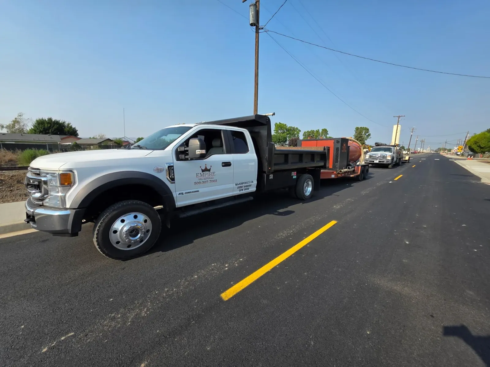 Empire work truck and vacuum equipment at a roadway jobsite